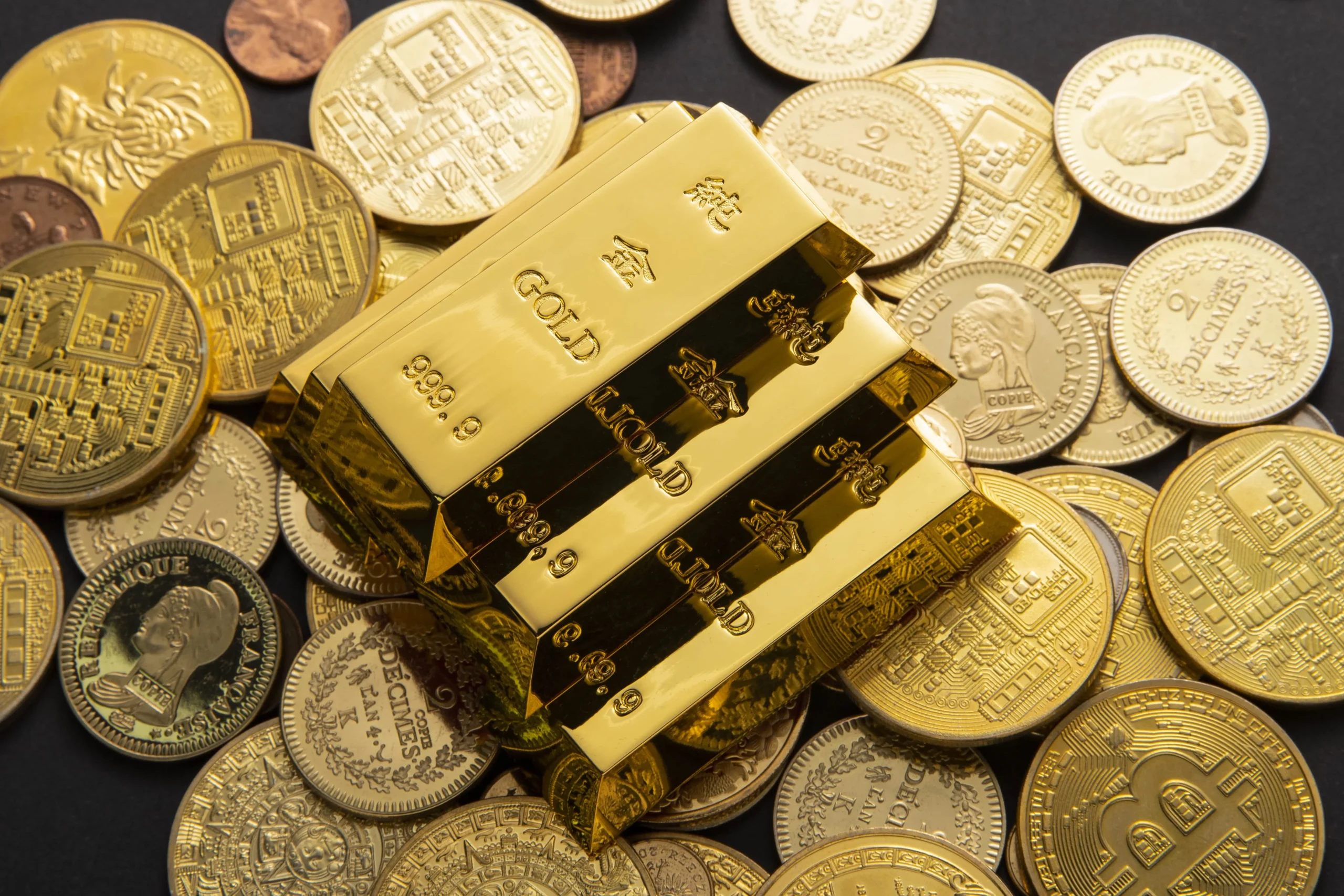 gold bars over gold coins